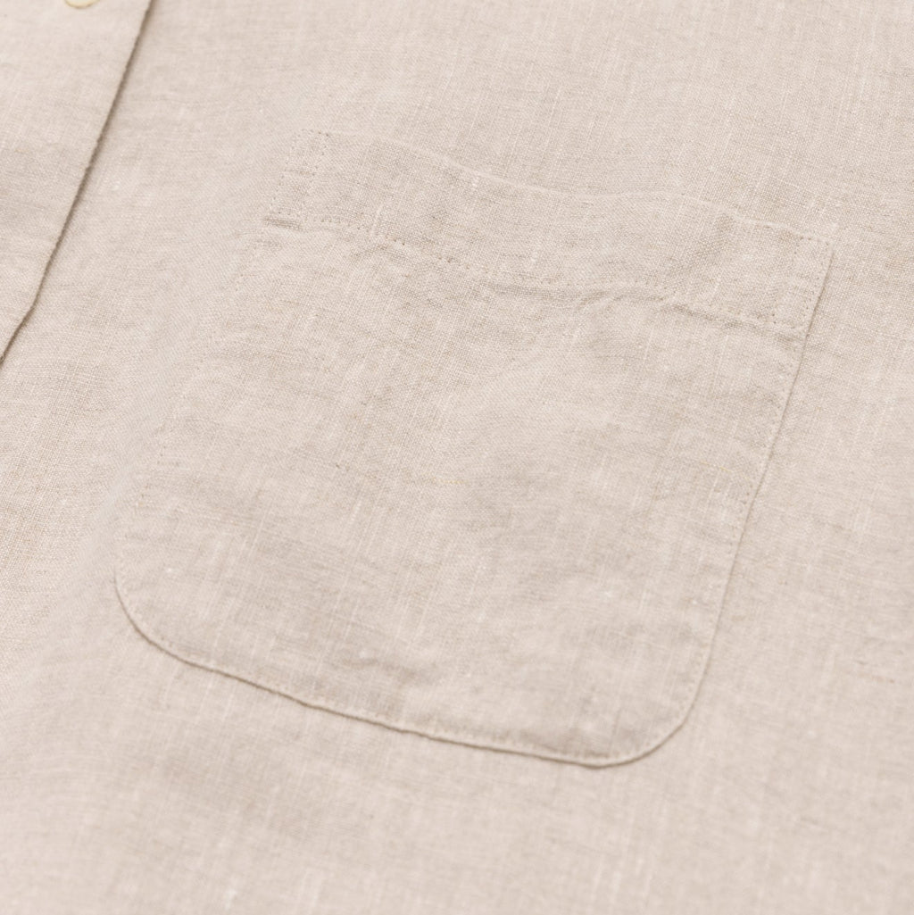 Close-up of a beige fabric pocket on a light beige background
