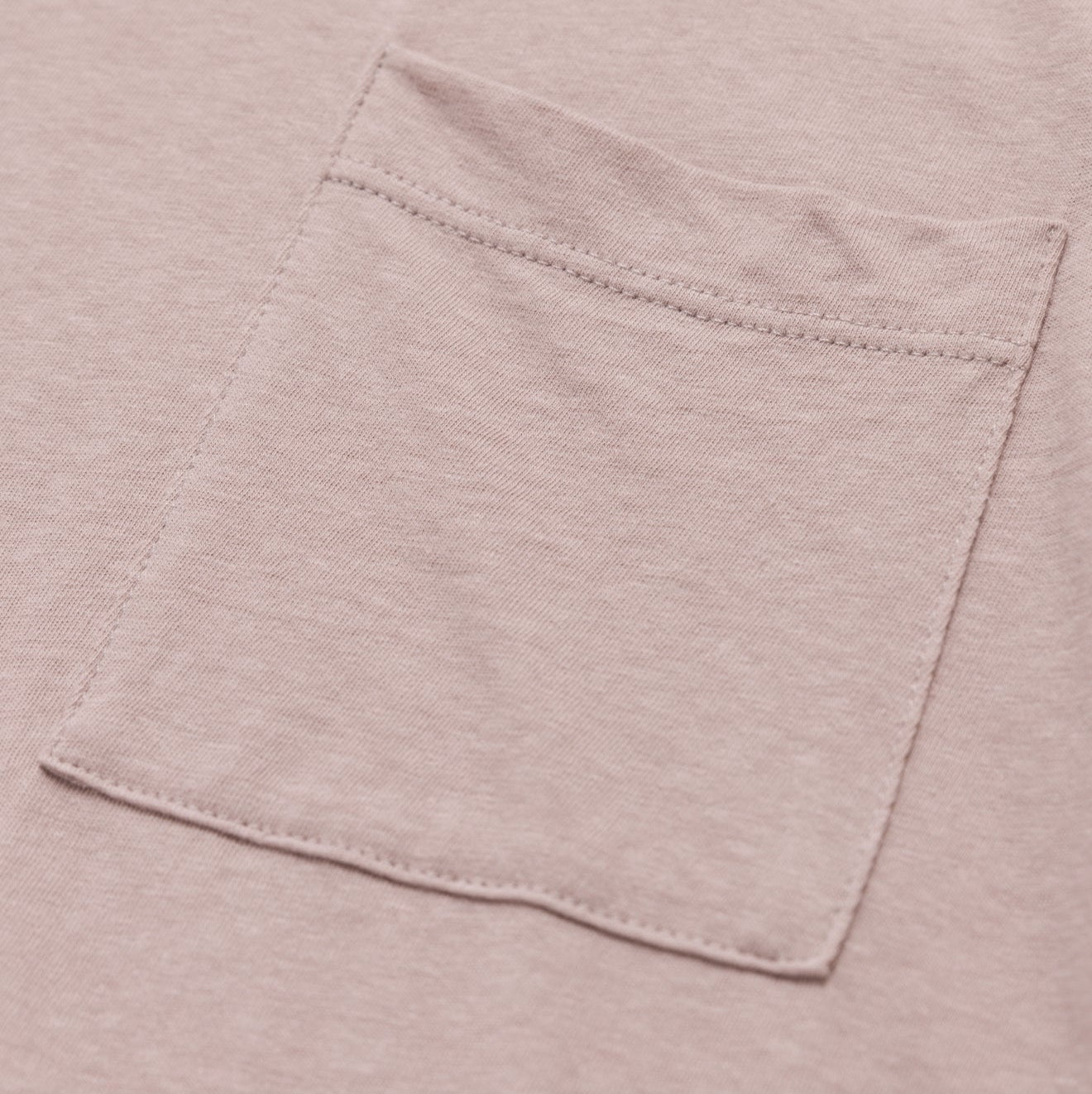 Close-up of a pocket on a light pink shirt
