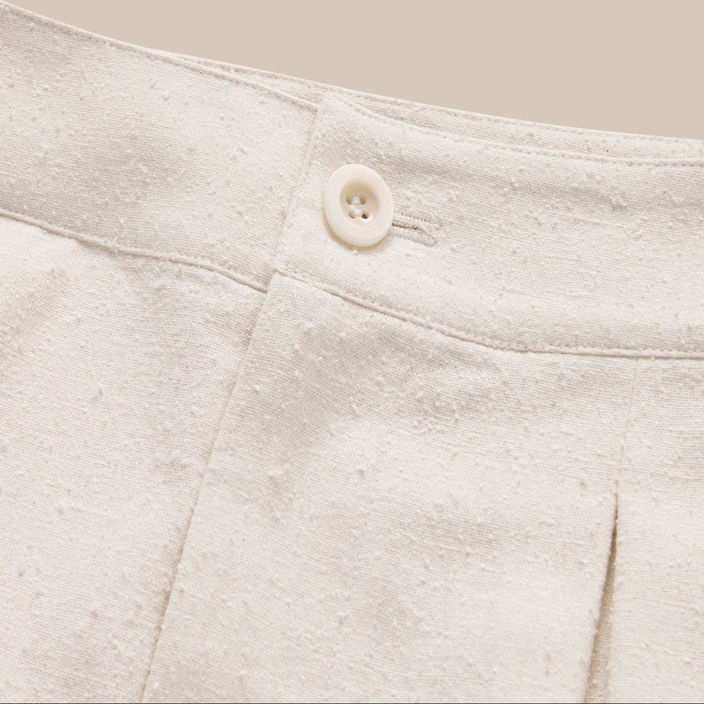 Close-up of a button on a light gray fabric