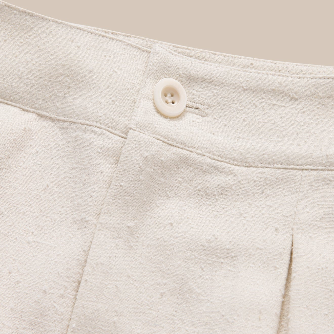 Close-up of a button on a light gray fabric